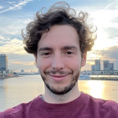 Gabriel Vergnaud, smiling, by the water at sunset